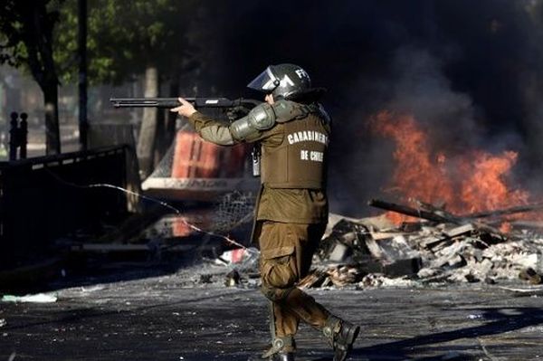 Military police shoots demonstrators during a protest in Concepción, Chile, October 2019. 