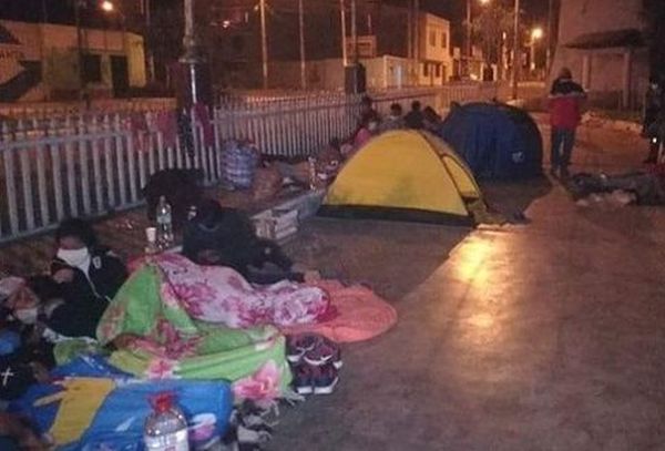 peruvians spending the night outside a hotel
