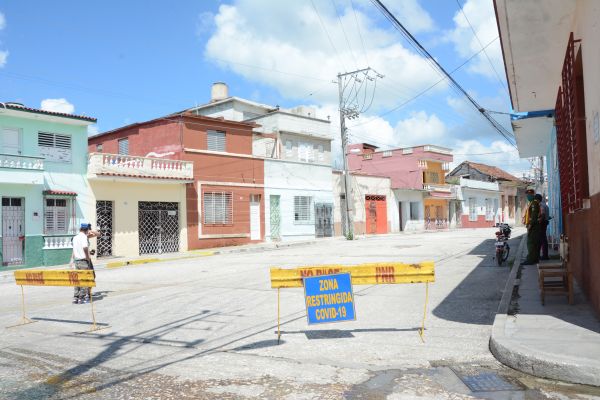 Authorities watch over a restricted area in the city of Sancti Spiritus 