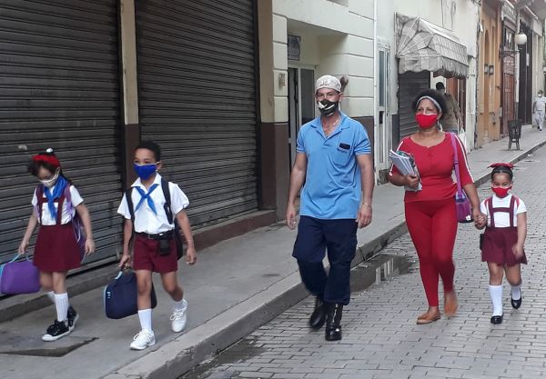 Children going to school accompanied by their relatives