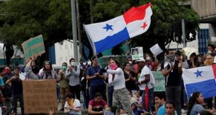 A protester flies a Panama flag during a student protest in front of the National Assembly in Panama City, Panama, Oct. 31, 2019